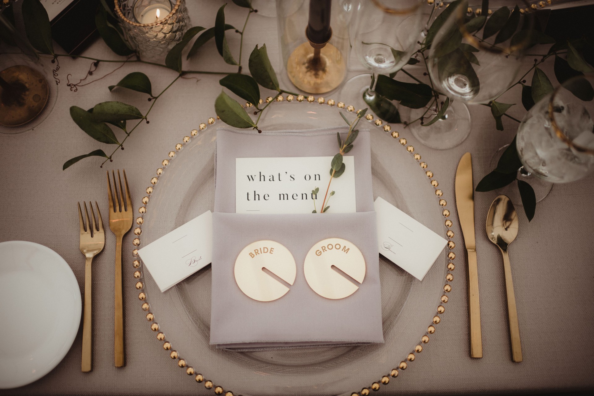 Elegant place setting at head table for bride and groom at wedding reception