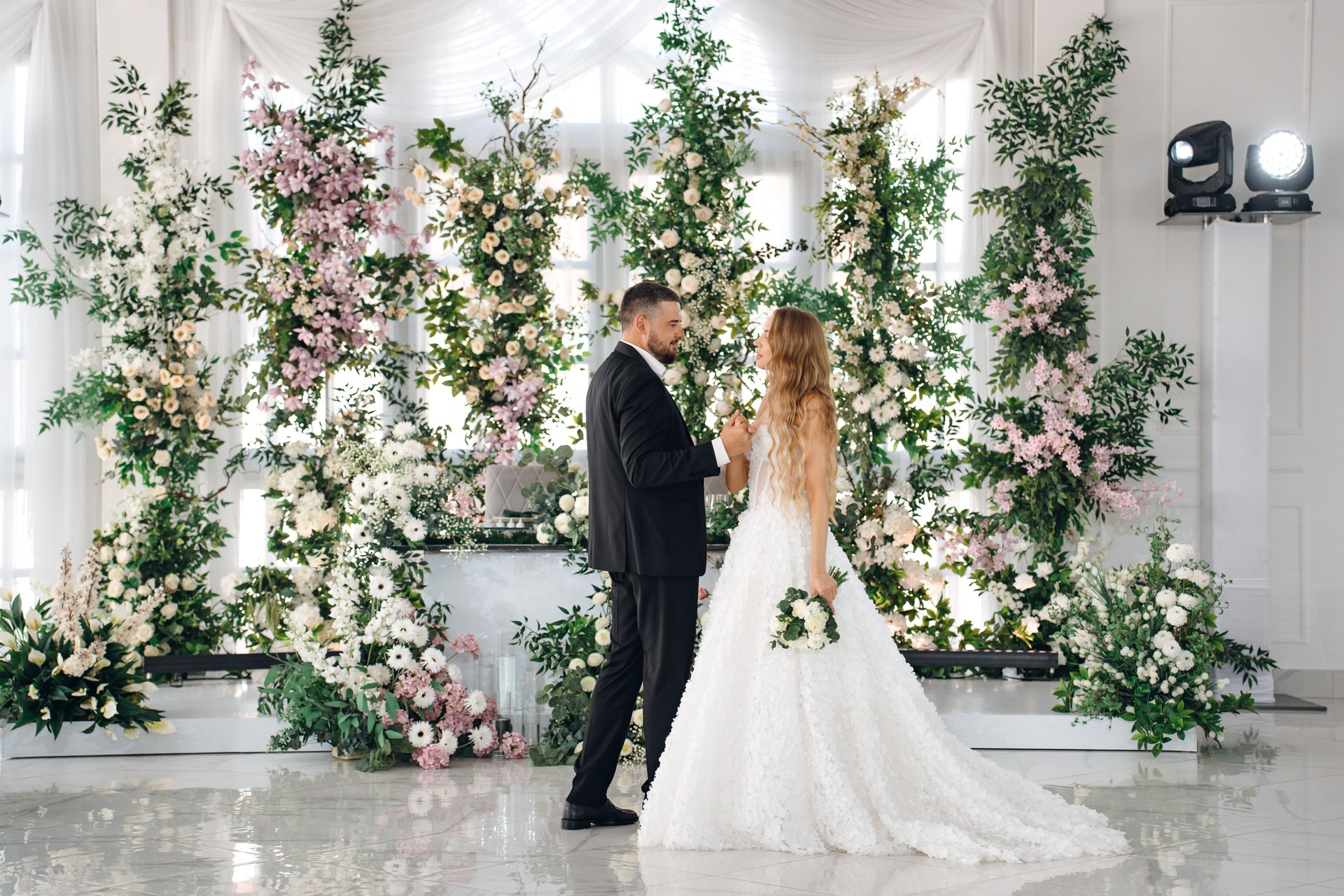 Beautiful and in love newlyweds dance in a banquet hall