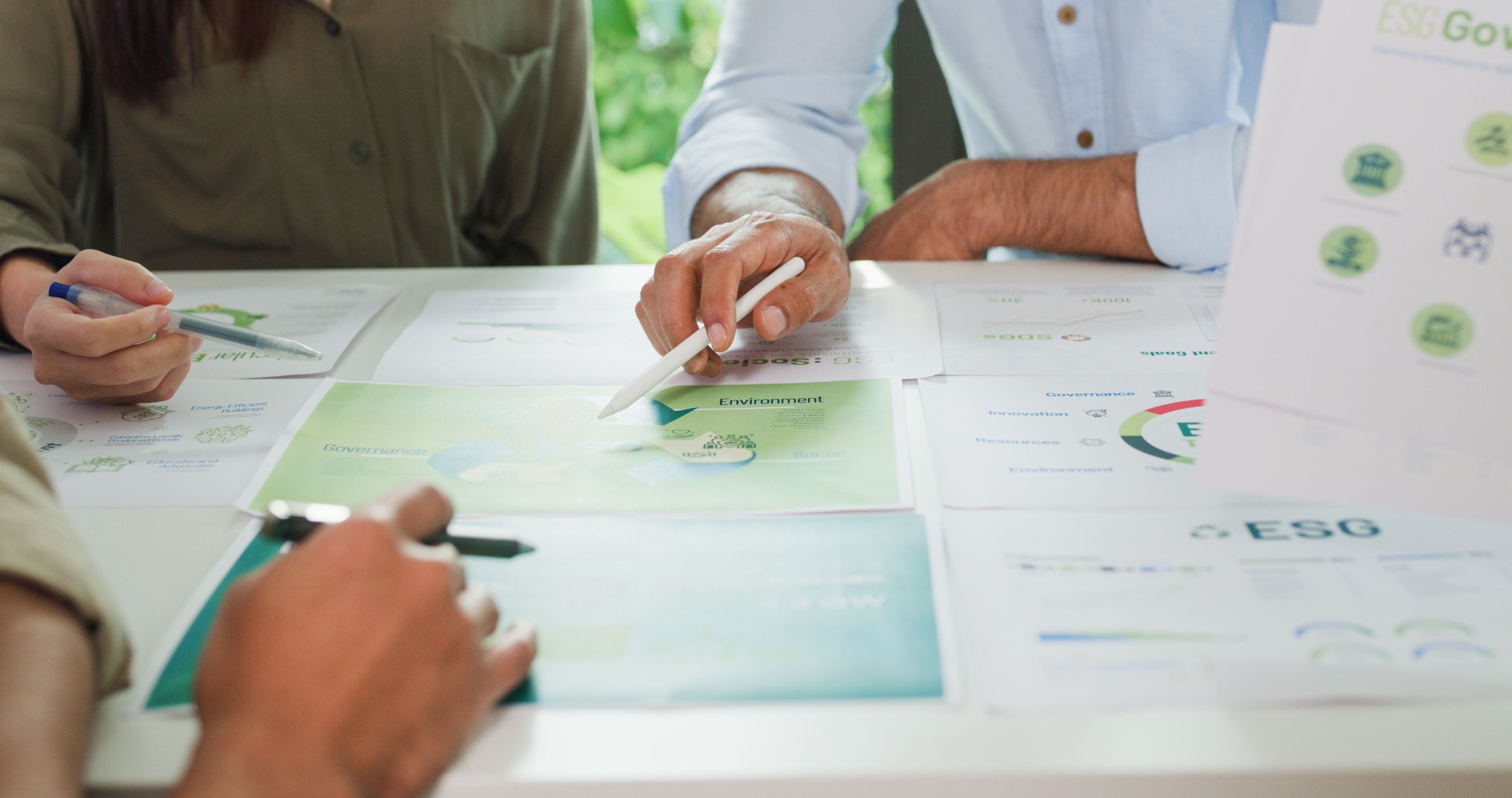 Closeup group businesspeople talk ESG strategies risk management workshop, SDGs report, global warming, green finance investment eco friendly and net zero waste in boardroom training building.